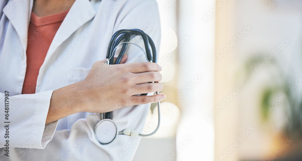 Woman, doctor and hands with stethoscope of professional in healthcare, cardiology or advice at hospital. Closeup of female person or medical expert with arms crossed, equipment or examination tool