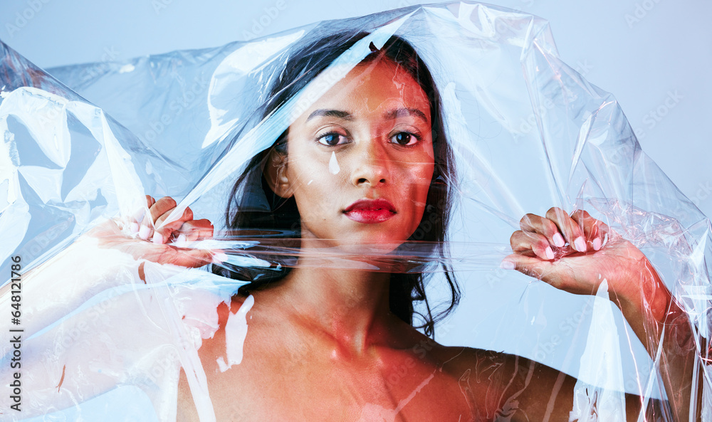 Plastic, woman and portrait with art, makeup and creativity in studio with cosmetics. Blue background, female person and packaging with unique aesthetic and skin glow with confidence and gloss