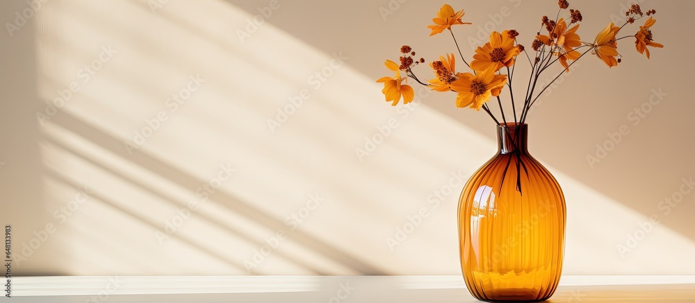 Room with flowers in an amber fluted glass vase