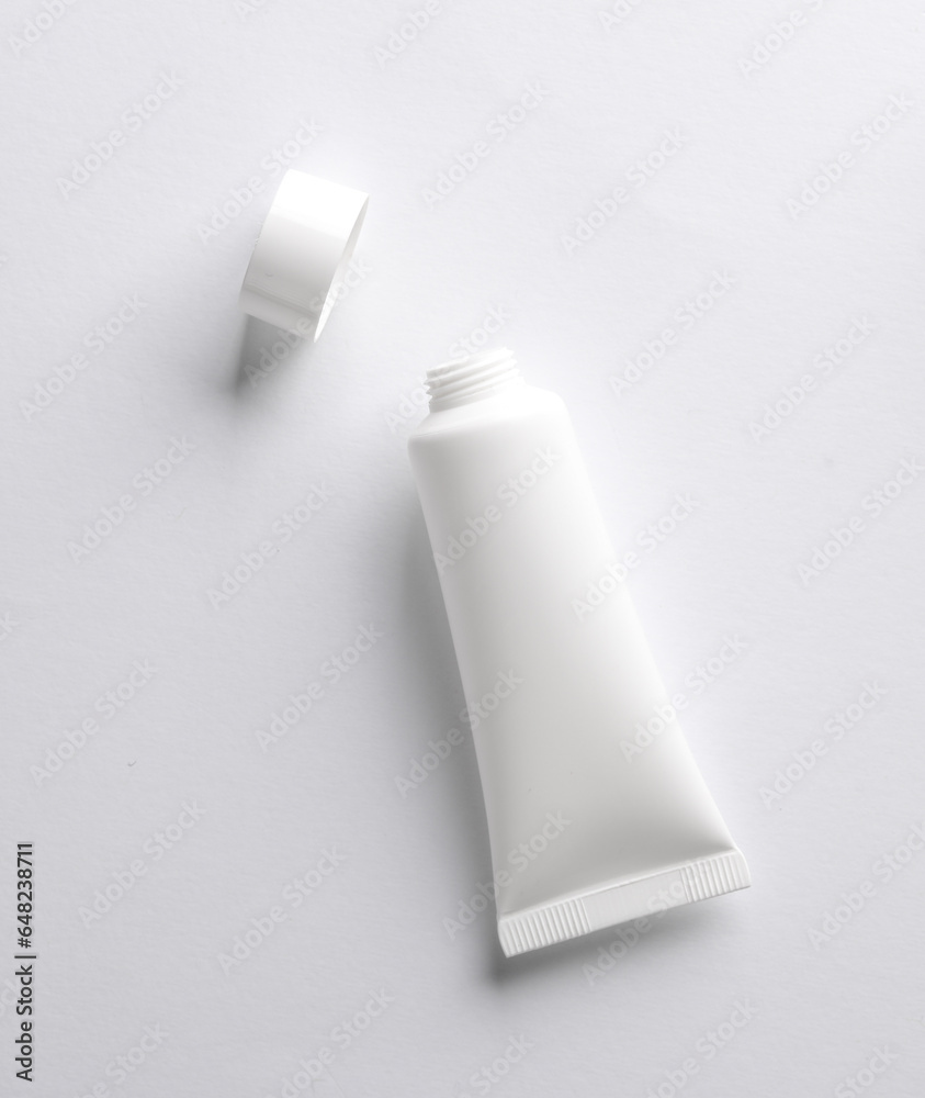 White Open cream tube on white background. Creative layout. Template for design. Mockup. Minmal beauty concept.