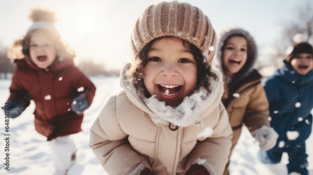 Happy group of children playing in the snow during winter.