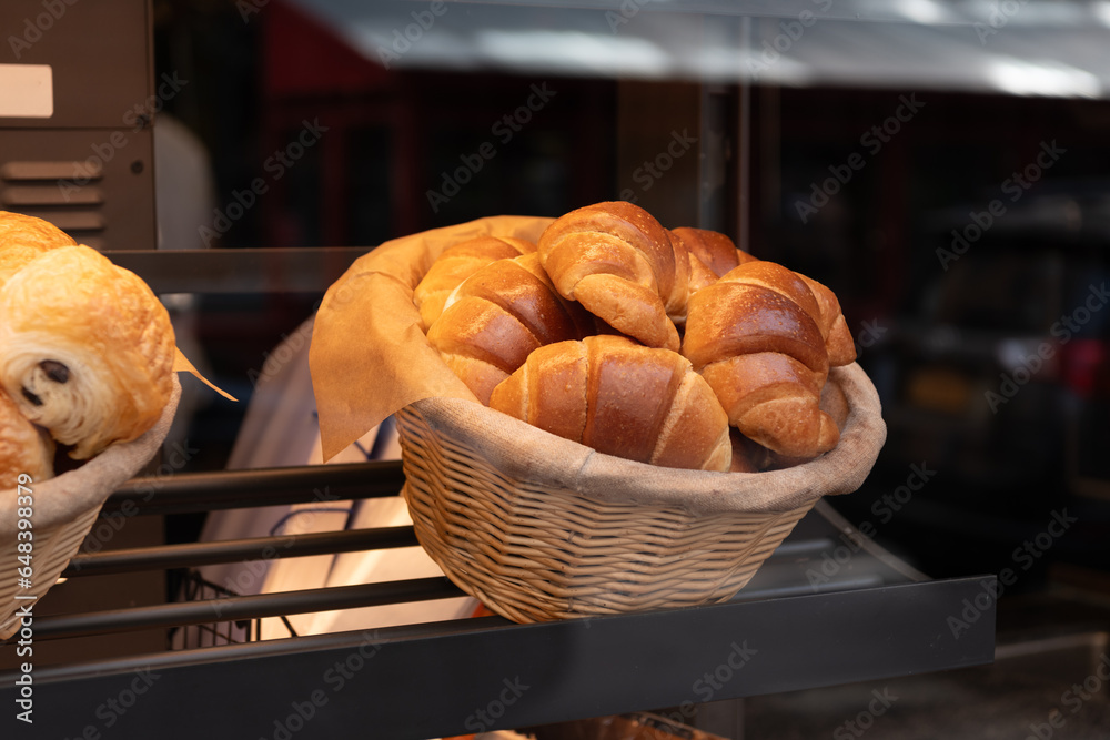 baked food. breakfast in cafe with cinnabon or croissant. bakery food. fresh baked cinnabon. french croissant pastry. fresh bakery. cinnabon croissant in basket at showcase