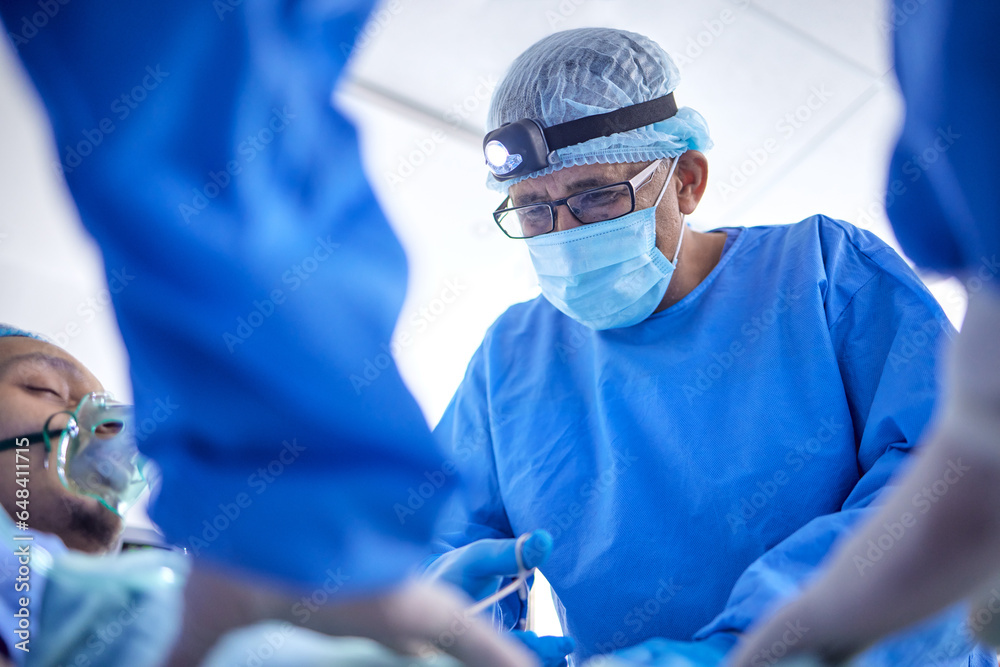 Scissors, hospital and surgeon team in theatre for emergency, healthcare or medical procedure. Doctors with a patient to start collaboration, surgery and operation with support and scrubs in ICU