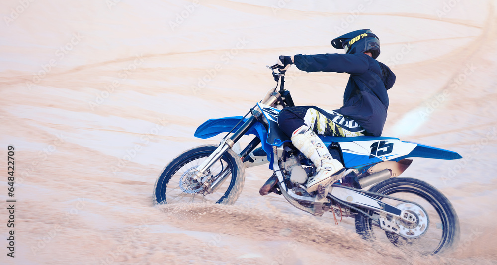 Sports, desert and athlete on bike for fitness, adrenaline and skill training for challenge. Action, dunes and man biker practicing for race, competition or performance adventure at off road rally.