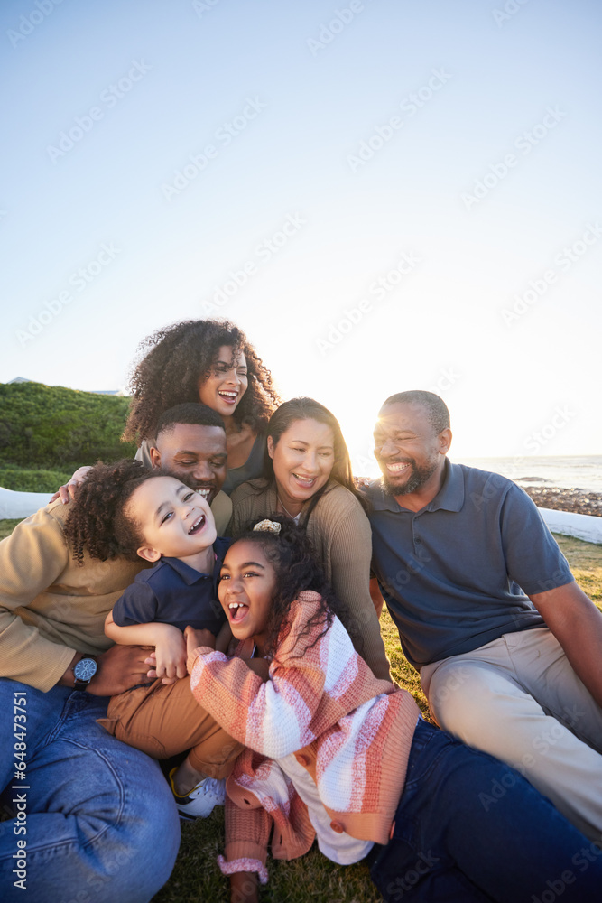 Family, laughing and outdoor with fun together with parents, kids and grandparents on holiday. Vacation, hug and happy mother, dad and young children with funny joke and game on grass with bonding