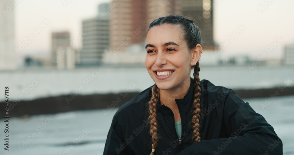 Fitness, smile and woman athlete in the city for a health, wellness and cardio workout or exercise. Happy, sports and young female person on a rest or break after training on rooftop in urban town.