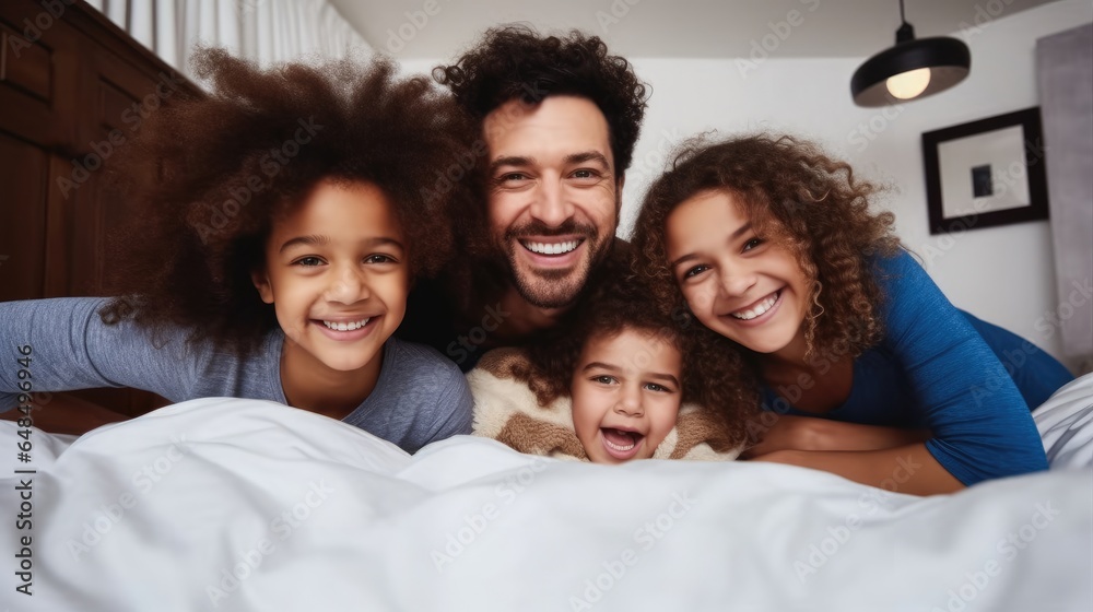 Happy family kids and parents rest on bed, Enjoy morning together, Bedroom portrait.