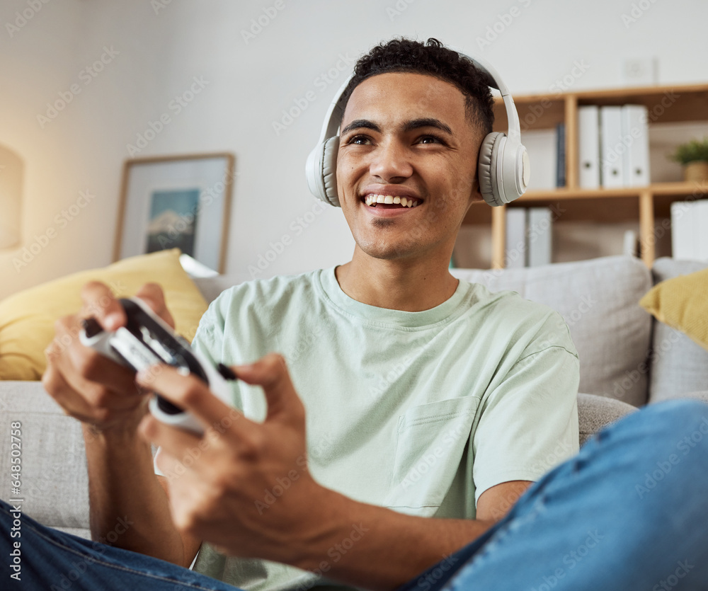 Home, game controller and man with headphones, relax and connection on a couch, sound and internet. Happy person, gamer and guy on a sofa, playing online and headset with audio, smile and esports