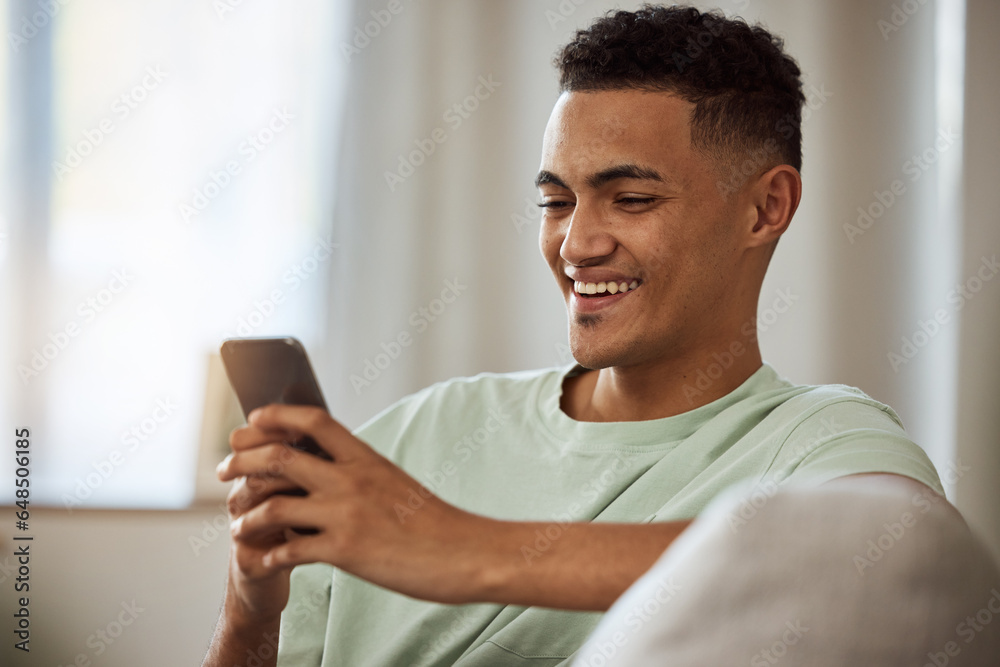 Home, smile and man with a cellphone, relax and typing with connection, digital app or social media. Person on a couch, lounge or guy with a smartphone, meme and website info with internet or network