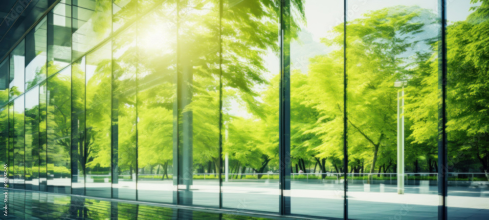 Modern building reflects nature and eco-friendly building in the city, sustainable glass building for reducing heat and carbon dioxide, Office building with a green environment, Blurred image