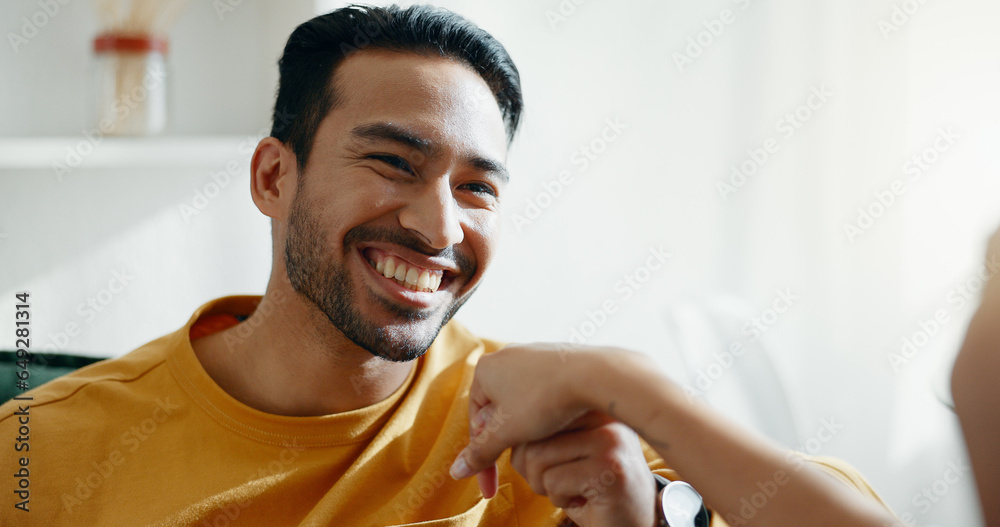 Holding hands, smile and couple on a sofa, relax and bond with conversation, romance and care at home. Happy, love and man in a living room with trust, support and smile while speaking in a house