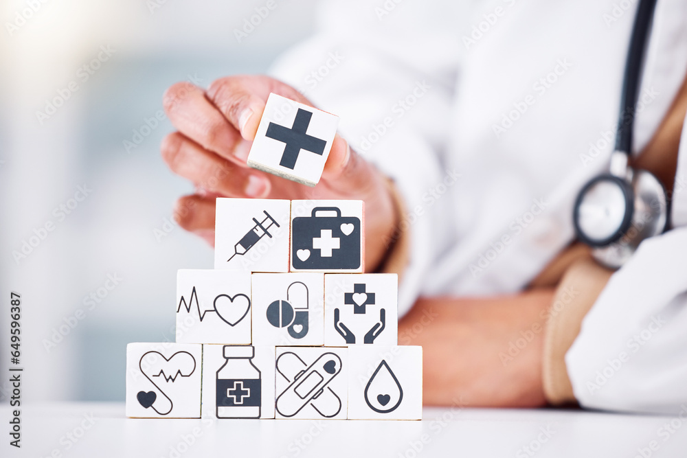 Hands, medical and a building blocks in a hospital with a doctor closeup for health insurance. Healthcare, icon and symbol with a medicine professional and tower in clinic for cardiology or treatment