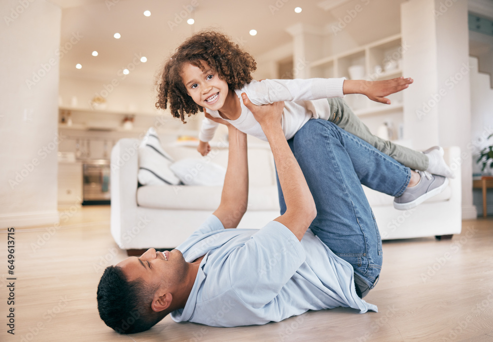 Father, kid and airplane game on floor, smile and portrait with support, home and care in a living room. Family, dad and child playing, fly and bonding with love, relax and happiness on weekend break