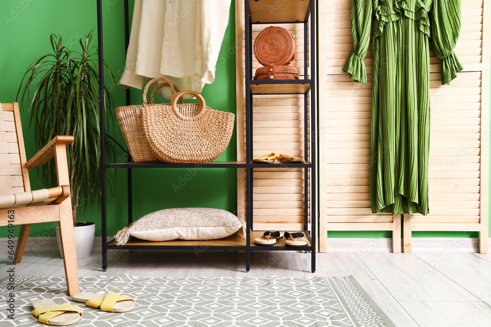 Shelving unit with clothes and accessories in dressing room