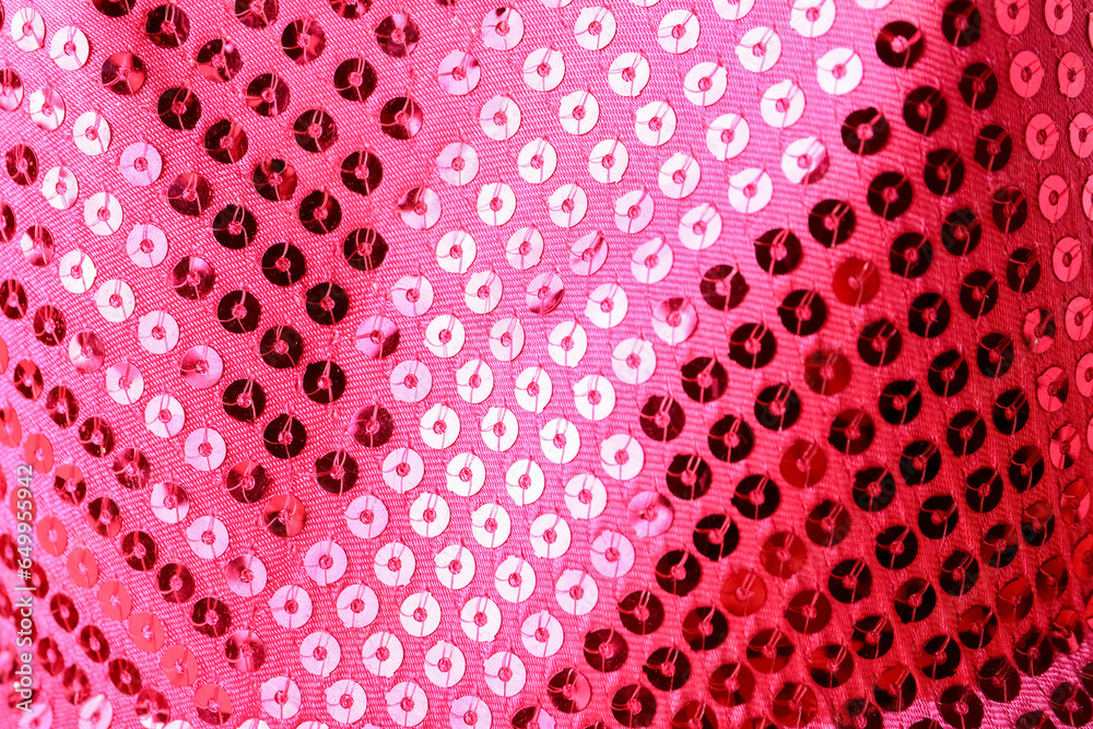 Closeup view of coral fabric with shiny sequins