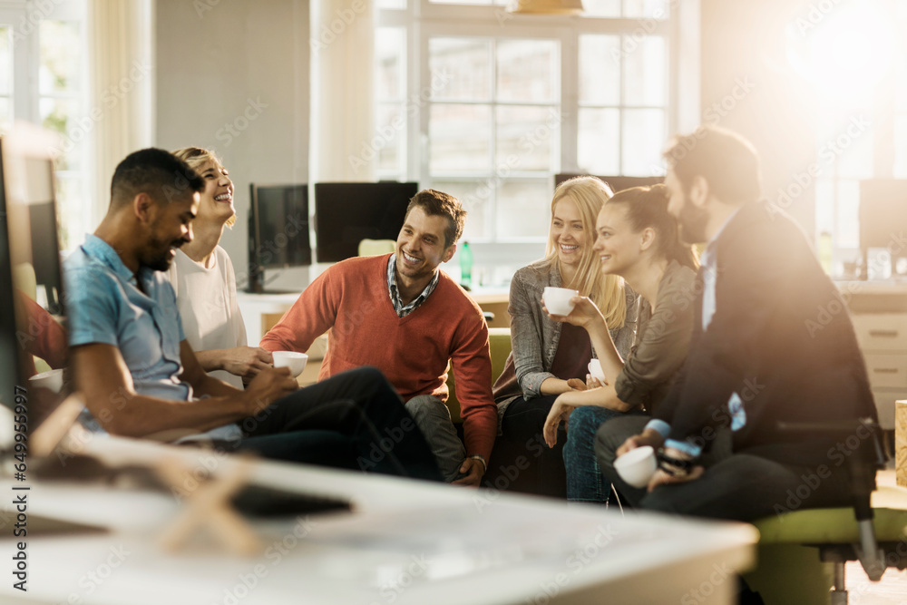 Young and diverse group of people having coffee and relaxing after work in the marketing company office