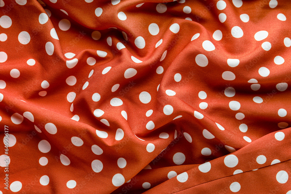 Closeup view of crumpled coral polka dot texture