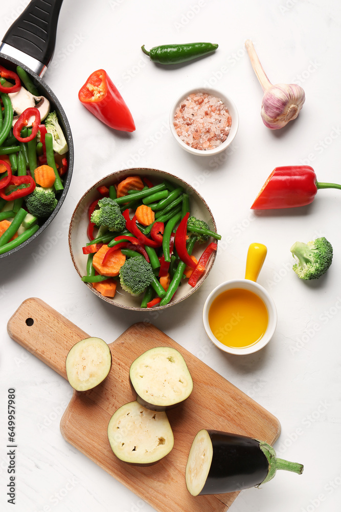 Bowl with fresh vegetables on light background