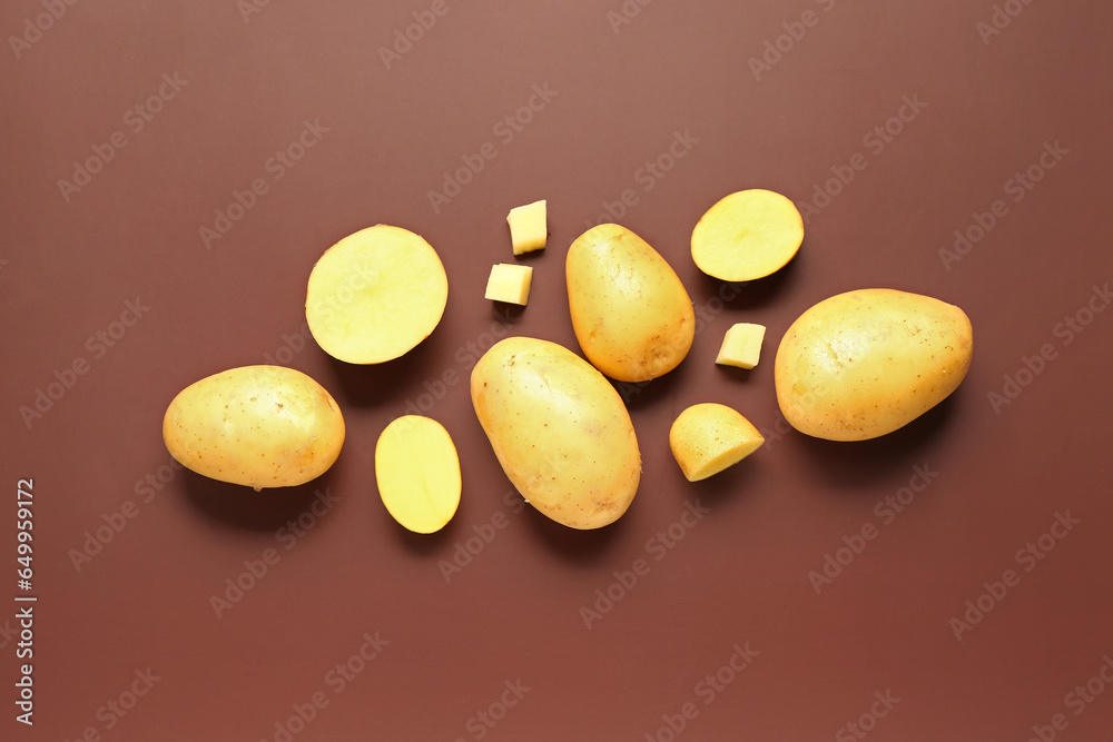 Raw potatoes on brown background