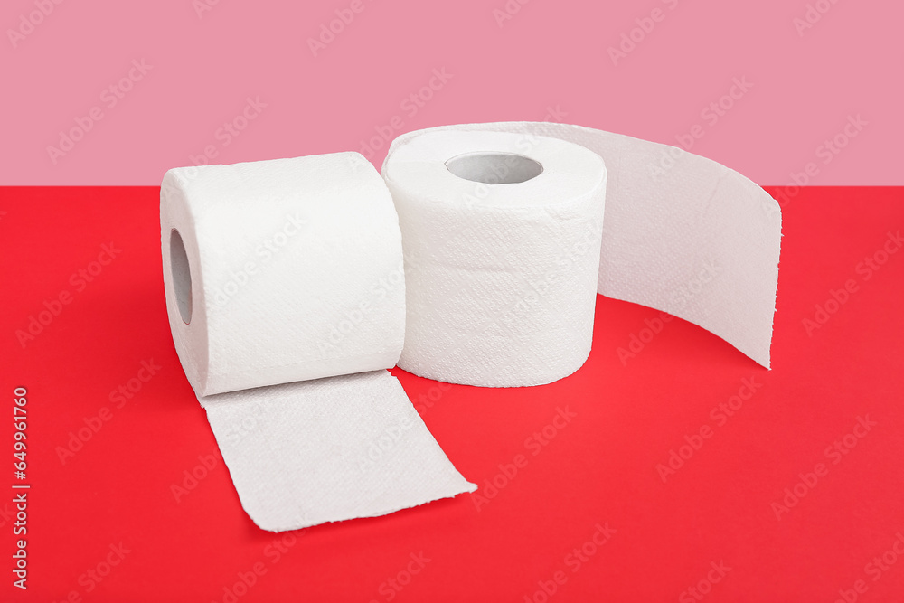 Rolls of toilet paper on colorful background