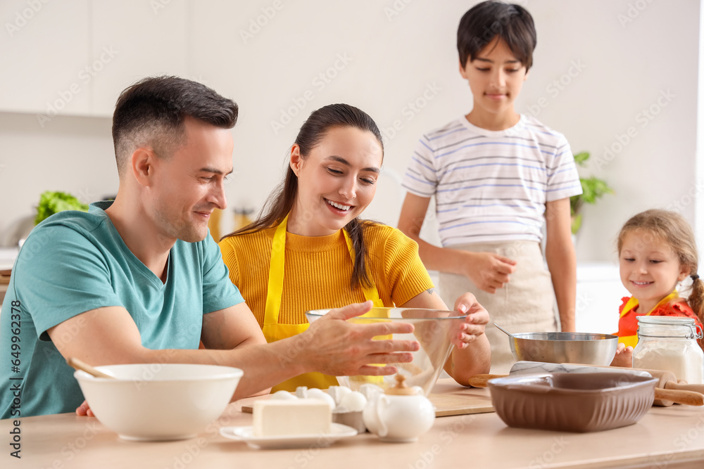 Happy family cooking in kitchen