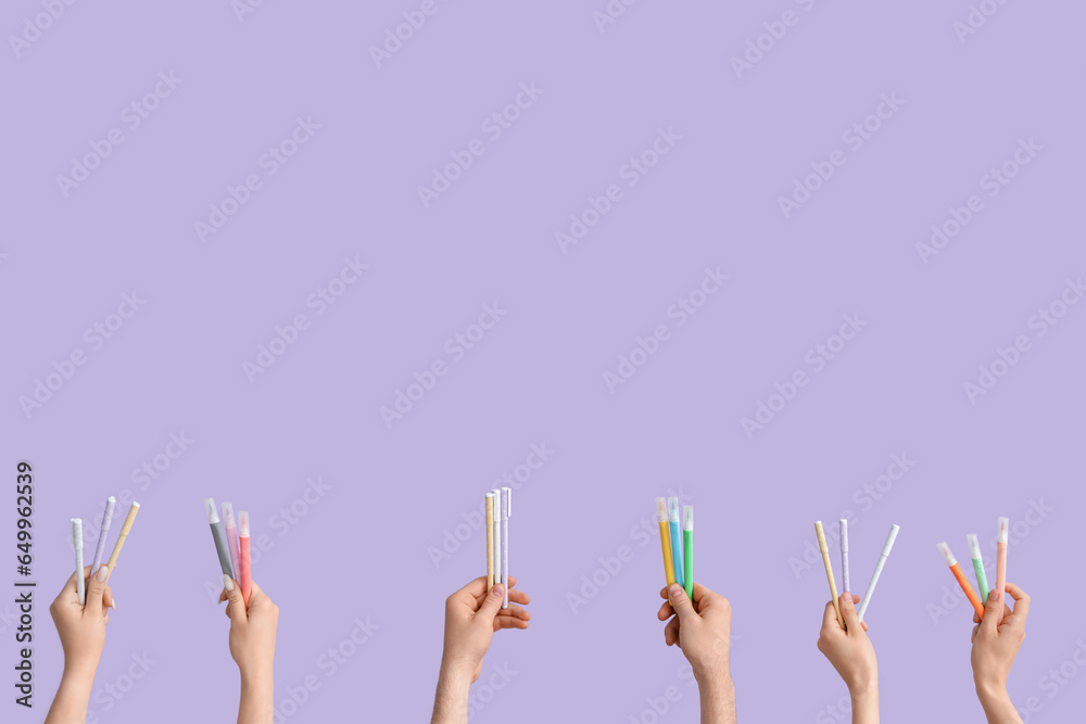 Hands with school supplies on lilac background