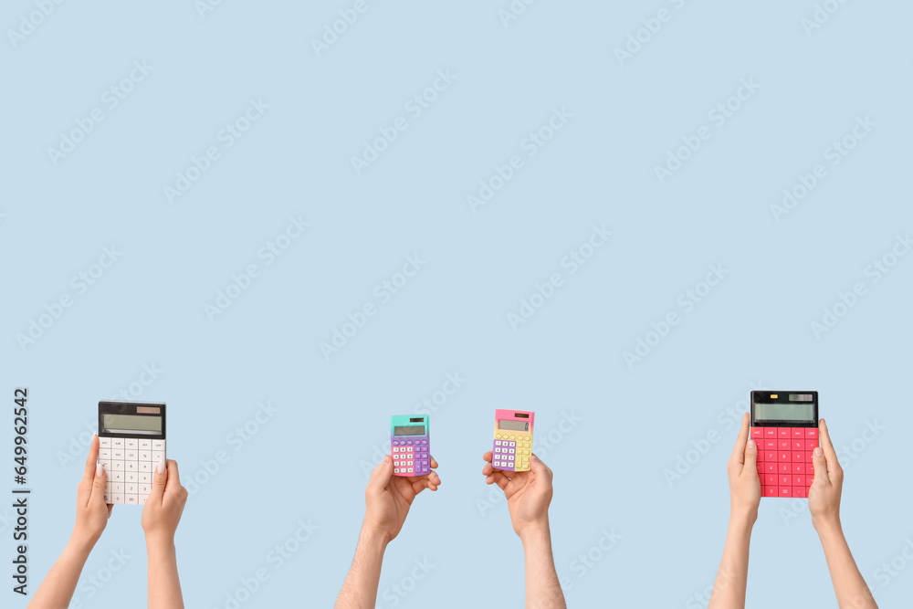 Hands with school supplies on blue background