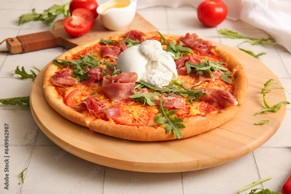 Wooden board of tasty pizza with Burrata cheese on white tile background