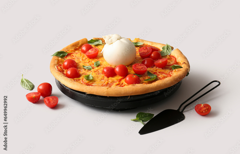 Wooden board of tasty pizza with Burrata cheese on grey background