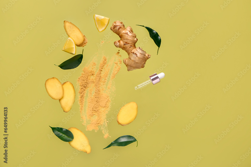 Flying slices of fresh ginger root with dried powder and cosmetic dropper on green background