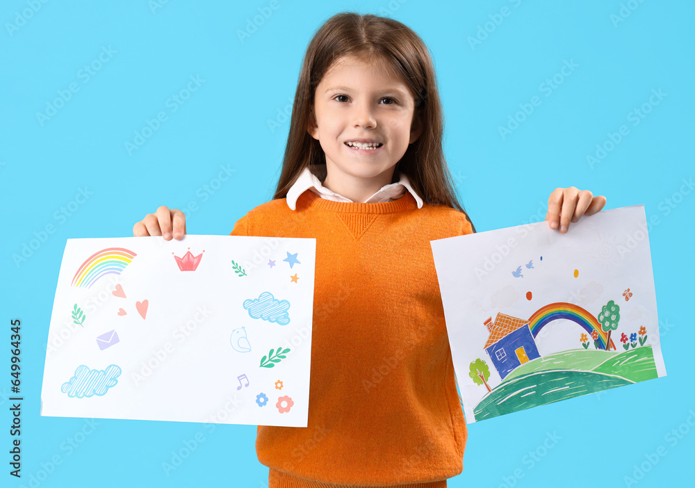 Cute little girl with drawings on blue background