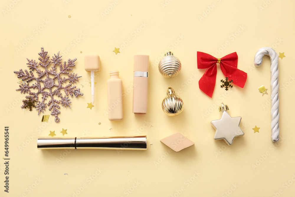 Composition with decorative cosmetics and Christmas decor on beige background