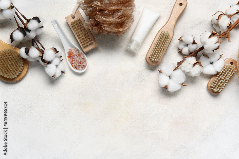 Composition with bath supplies, cosmetics and cotton branches on light background