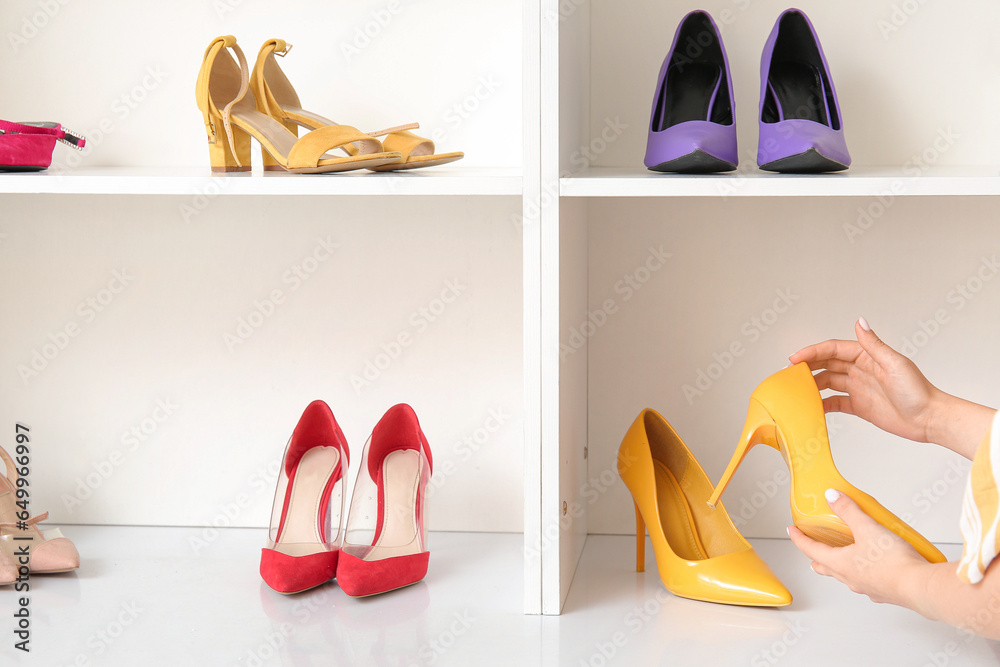 Woman choosing shoes in boutique