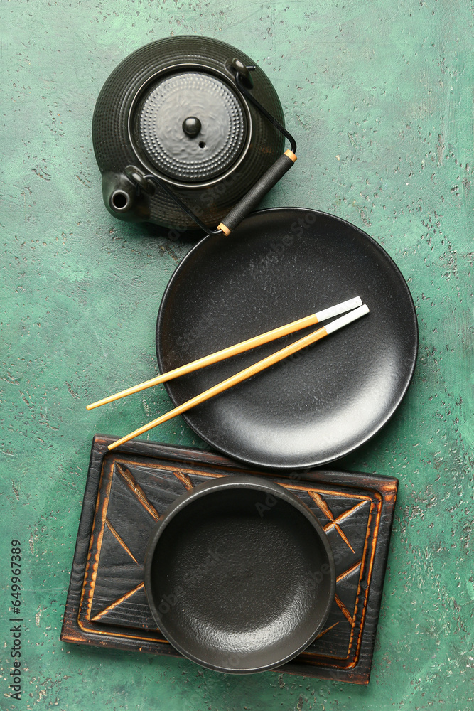 Chinese table setting with teapot on green background