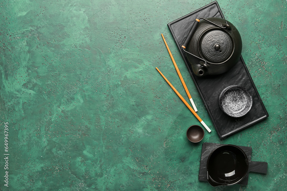 Chinese table setting with teapot on green background