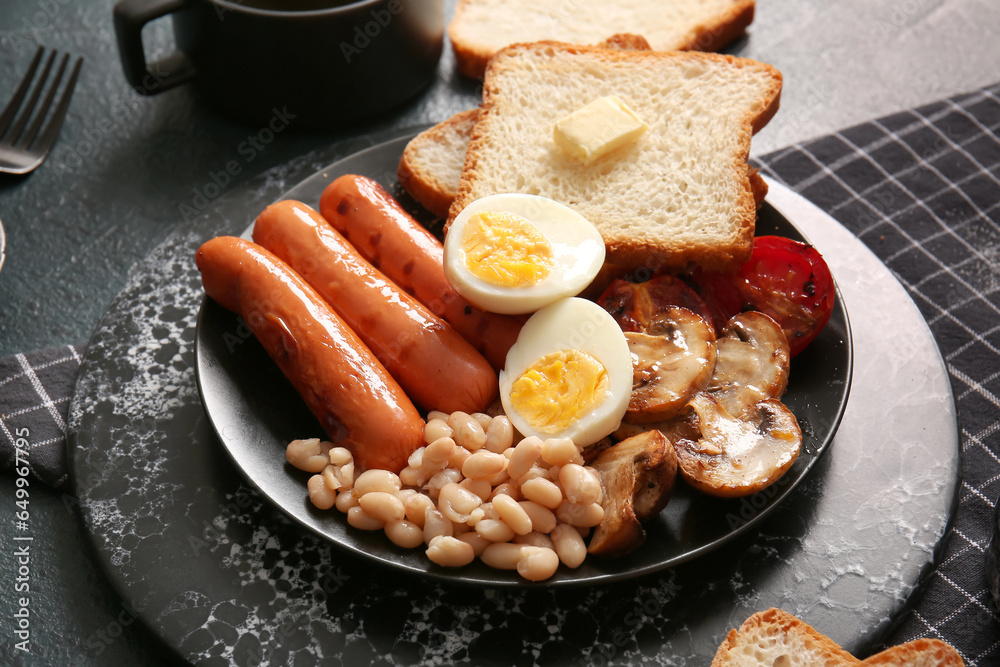 Plate of tasty English breakfast with boiled egg on black background