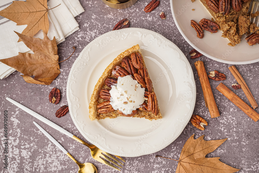 Plates with pieces of tasty pecan pie on grey background