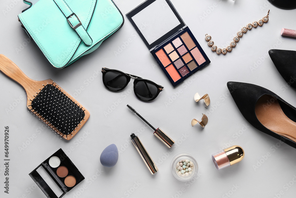 Composition with stylish female accessories, shoes and cosmetics on light background