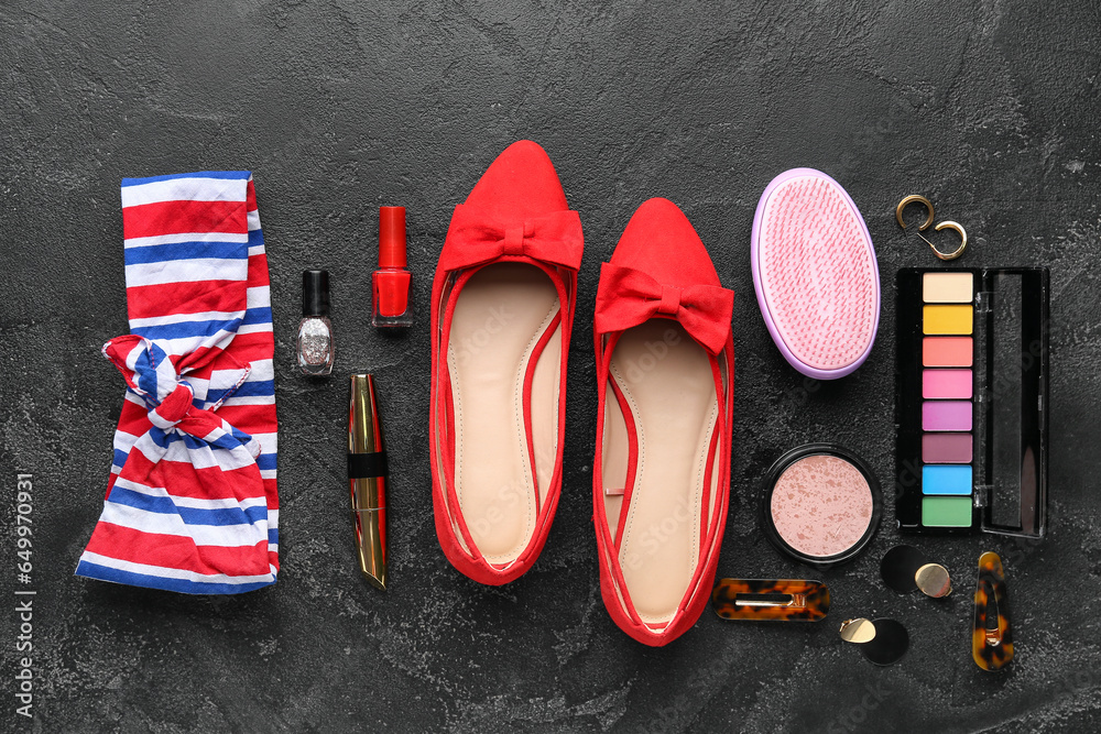 Composition with cosmetics, female accessories and shoes on dark background