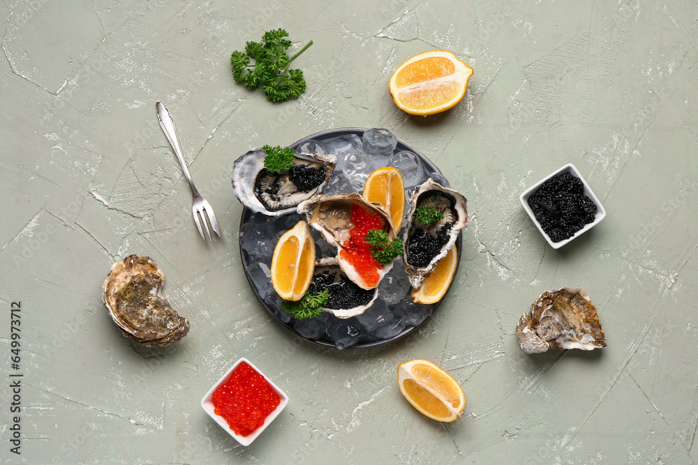 Plate of tasty oysters with lemon, black and red caviar on grey background