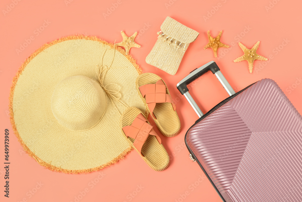 Composition with stylish beach accessories, suitcase and starfishes on color background