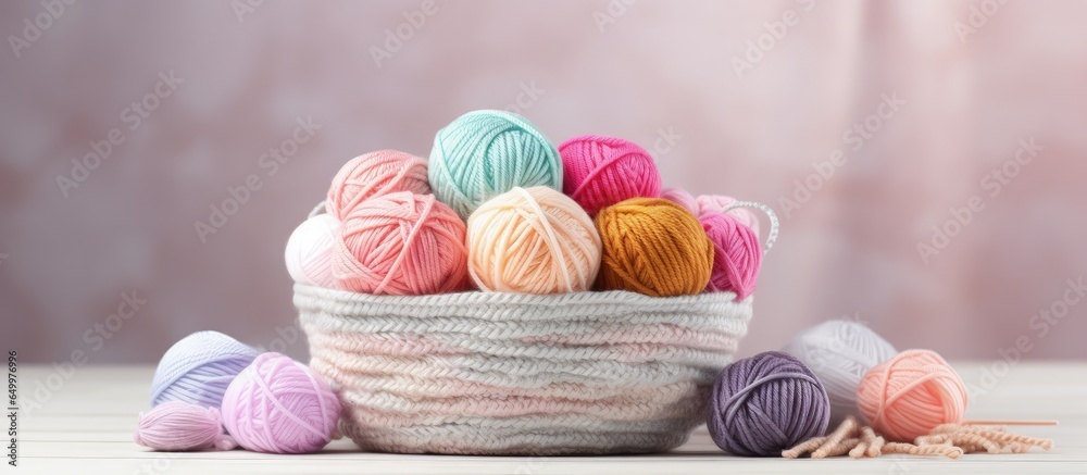 Knitting and crochet create a cozy atmosphere with multicolored yarn in a basket emphasizing the hobby concept with skeins and balls Copy space available