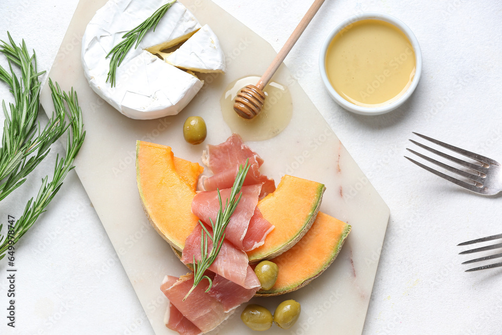 Composition with tasty melon, prosciutto, cheese and honey on light background, closeup