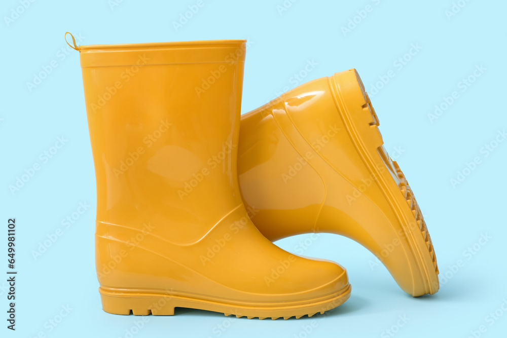 Yellow gumboots on blue background