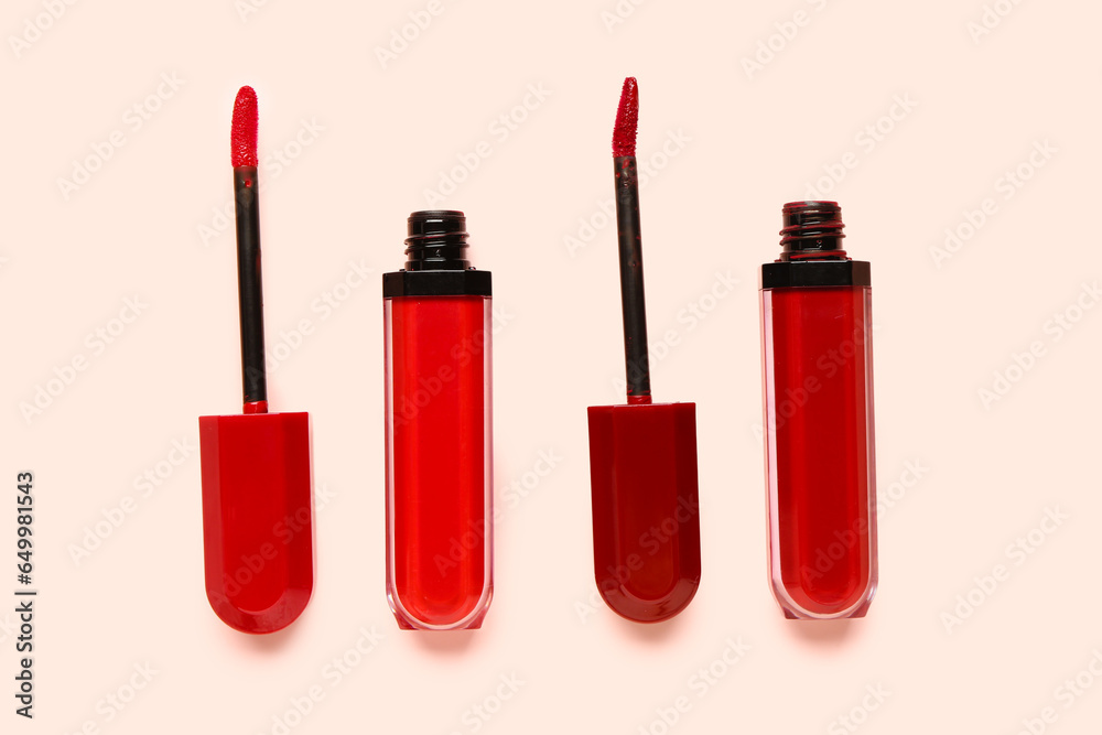 Different new red lipsticks on beige background