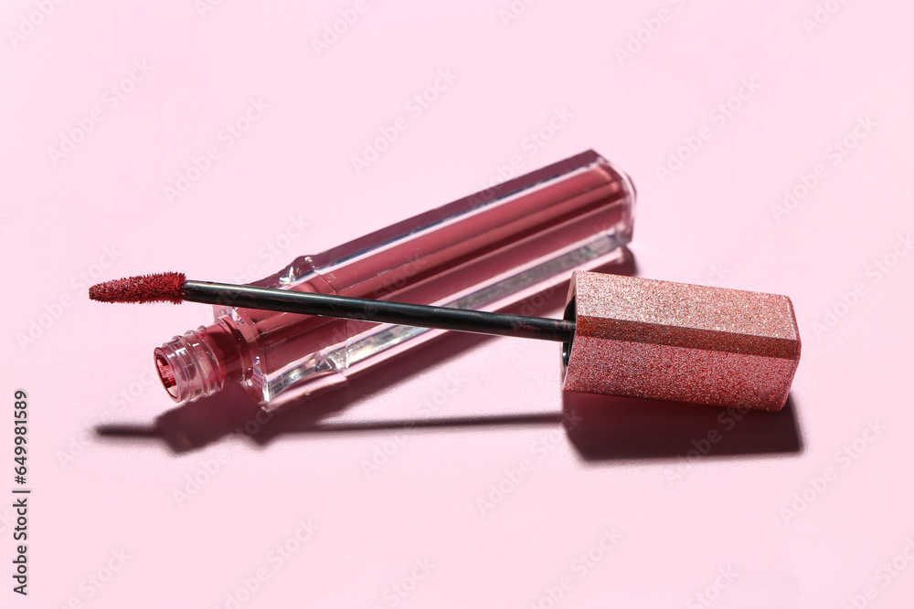 Stylish lipstick with brush on pink background, closeup