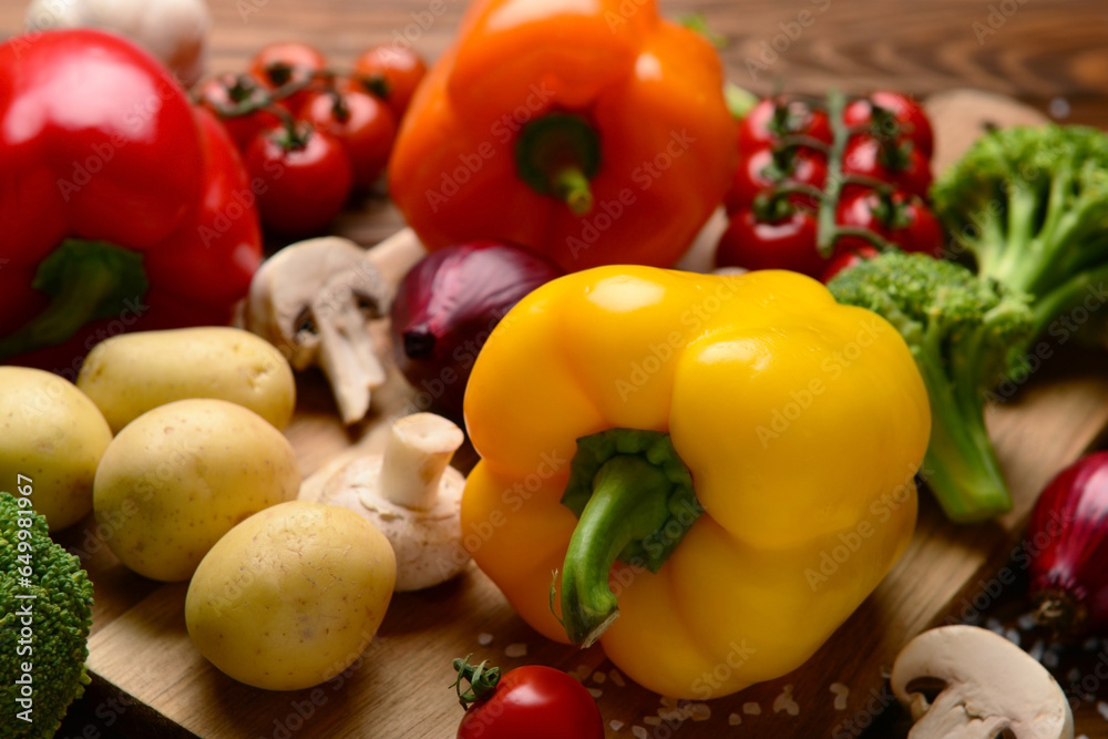 Board with different fresh vegetables on table