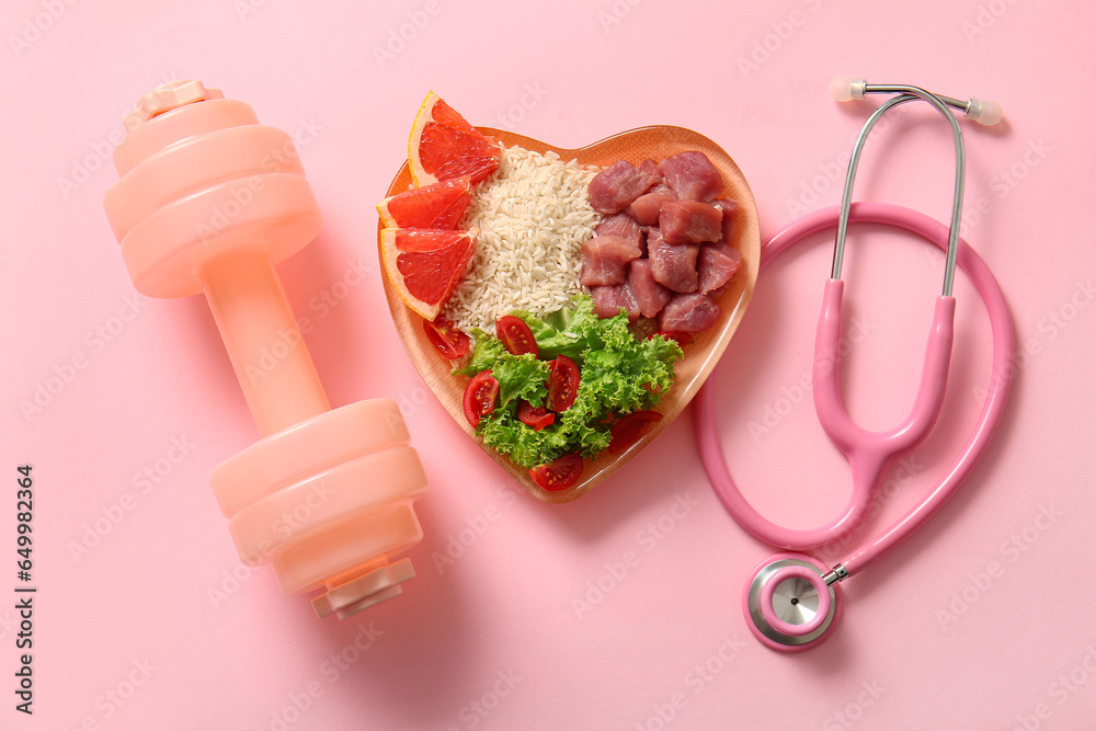 Plate with fresh healthy products, dumbbell and stethoscope on pink background. Diet concept