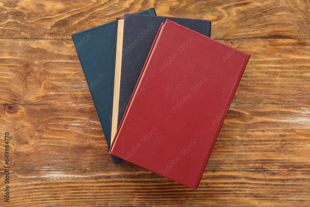 Old hardcover books on wooden background